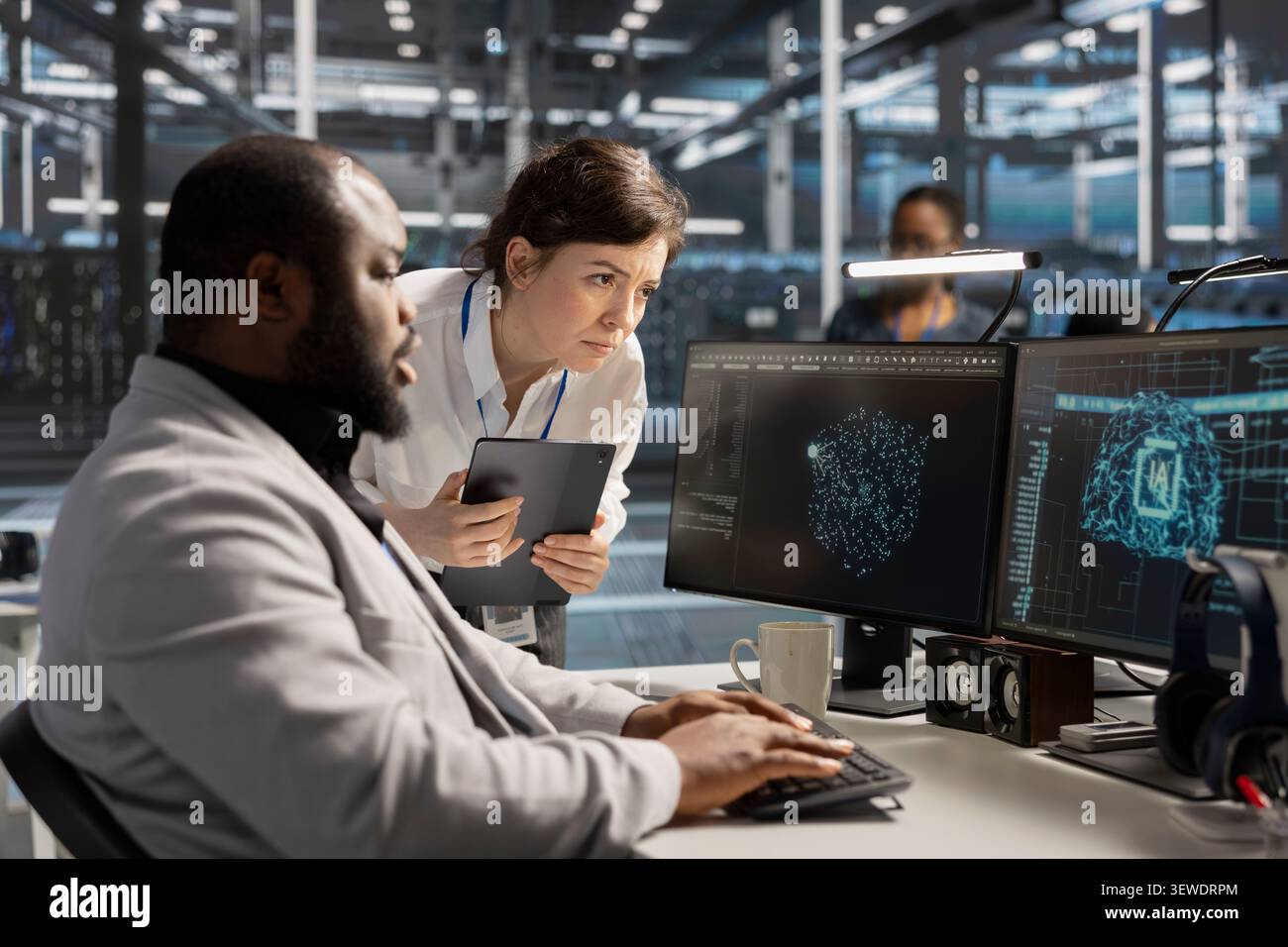 Data center manager reviews artificial intelligence systems and machine learning processes inside a data center. Stock Photo