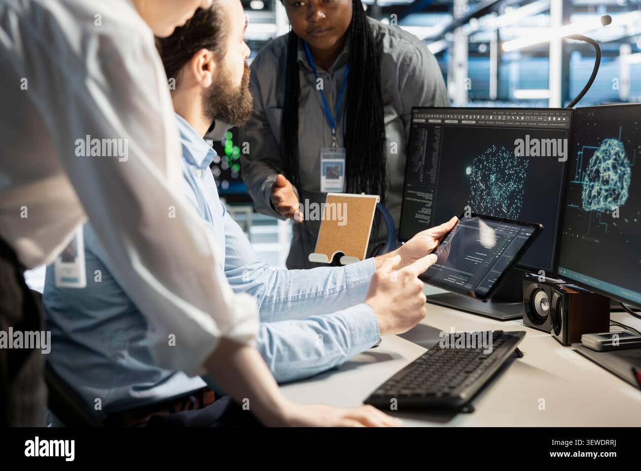 Data center programmers use a digital device in a data center to manage AI simulation and optimize server infrastructure. Stock Photo
