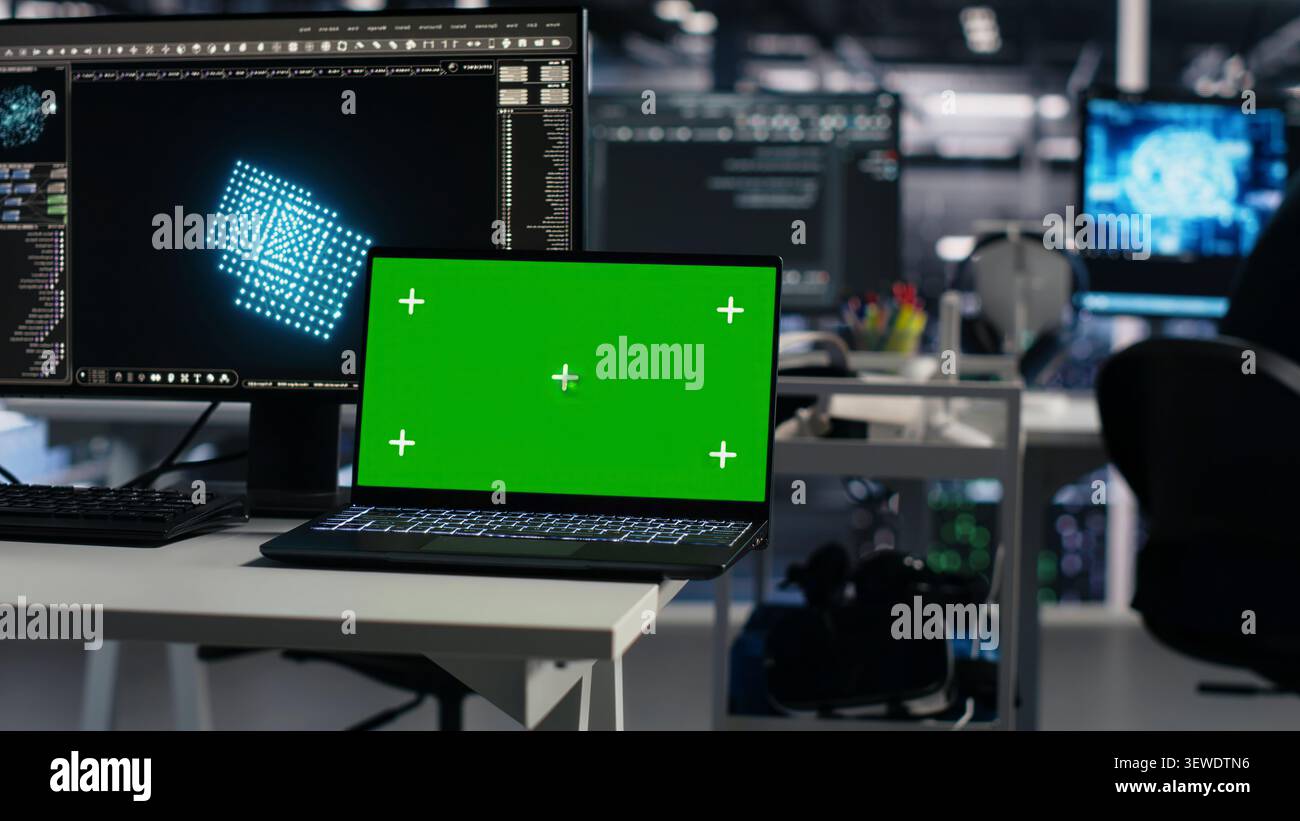 Software developer uses a green screen laptop to manage AI systems, machine learning workflows and server performance. Stock Photo