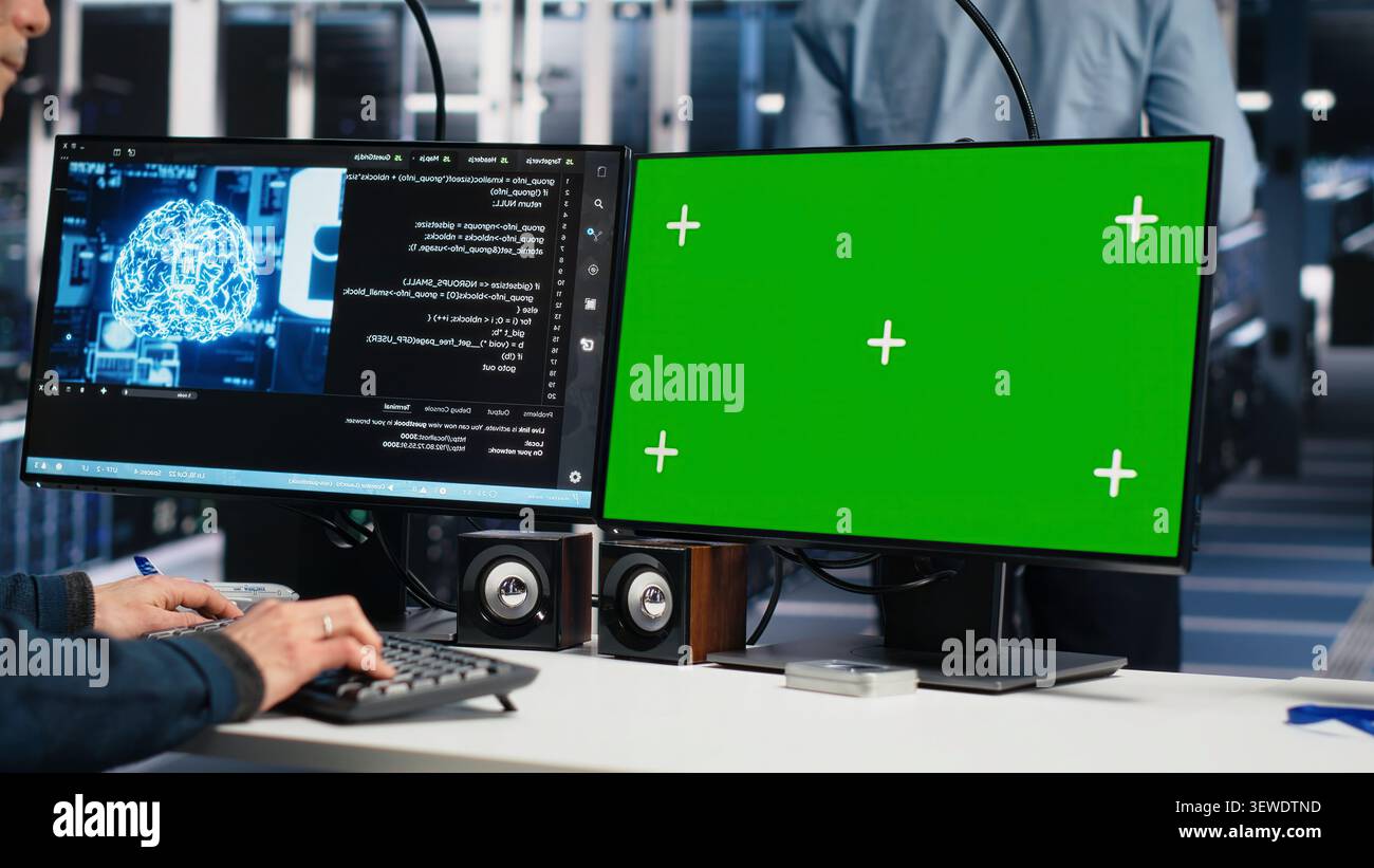 Software developer uses a green screen computer to manage AI systems, machine learning workflows and server performance. Stock Photo