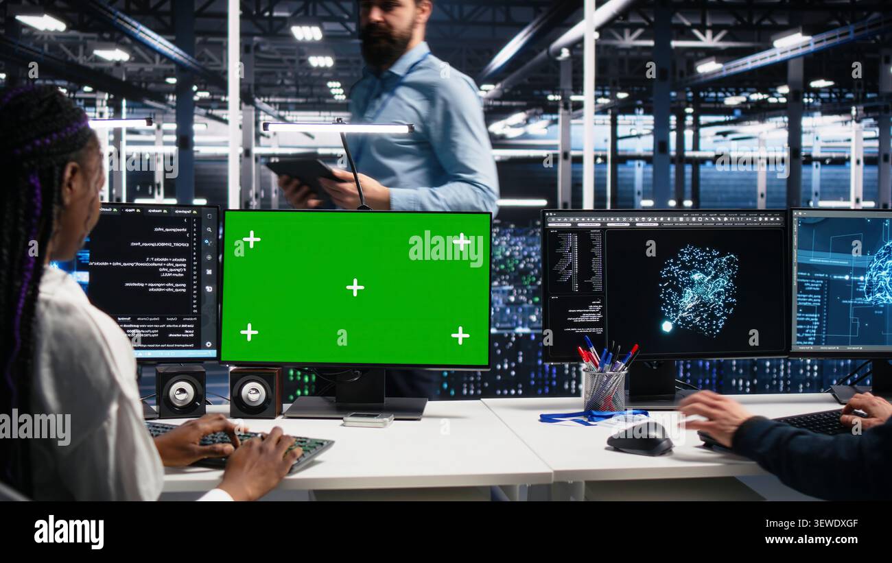 IT colleagues collaborate in a data center while reviewing AI diagnostics and infrastructure performance. Stock Photo