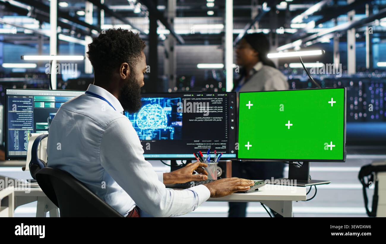 System administrator uses node tree AI software on a green screen computer for data center analysis. Stock Photo