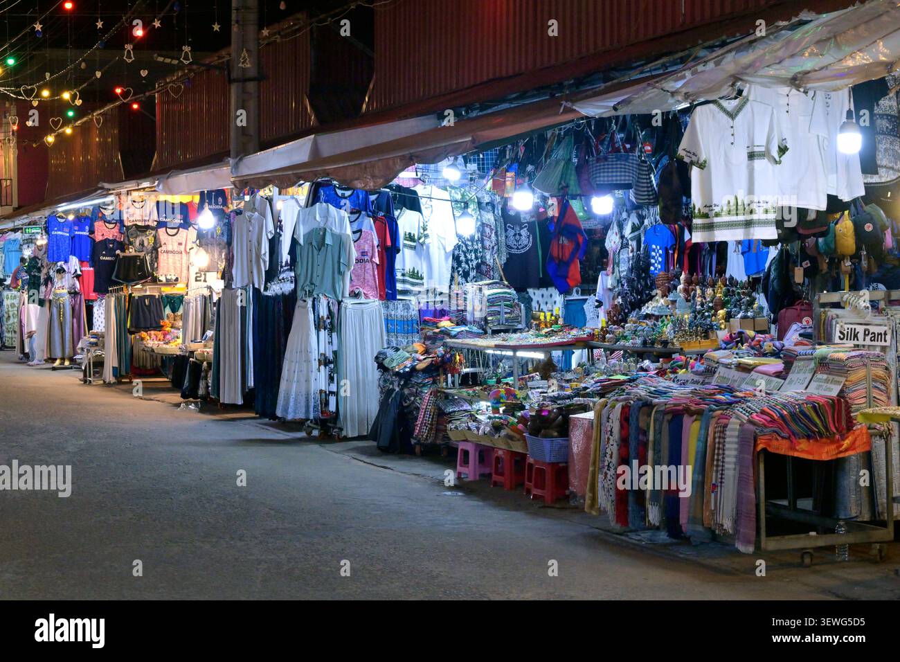 Clothes and souvenirs for sale at one of the night markets in Siem Reap, Cambodia. Stock Photo