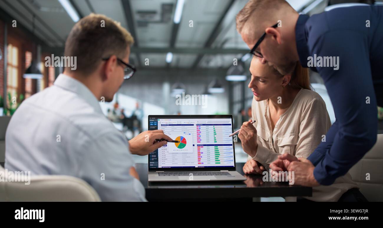Medical Billing Analyst And Team Reviewing Coding Spreadsheets On Laptops. Stock Photo