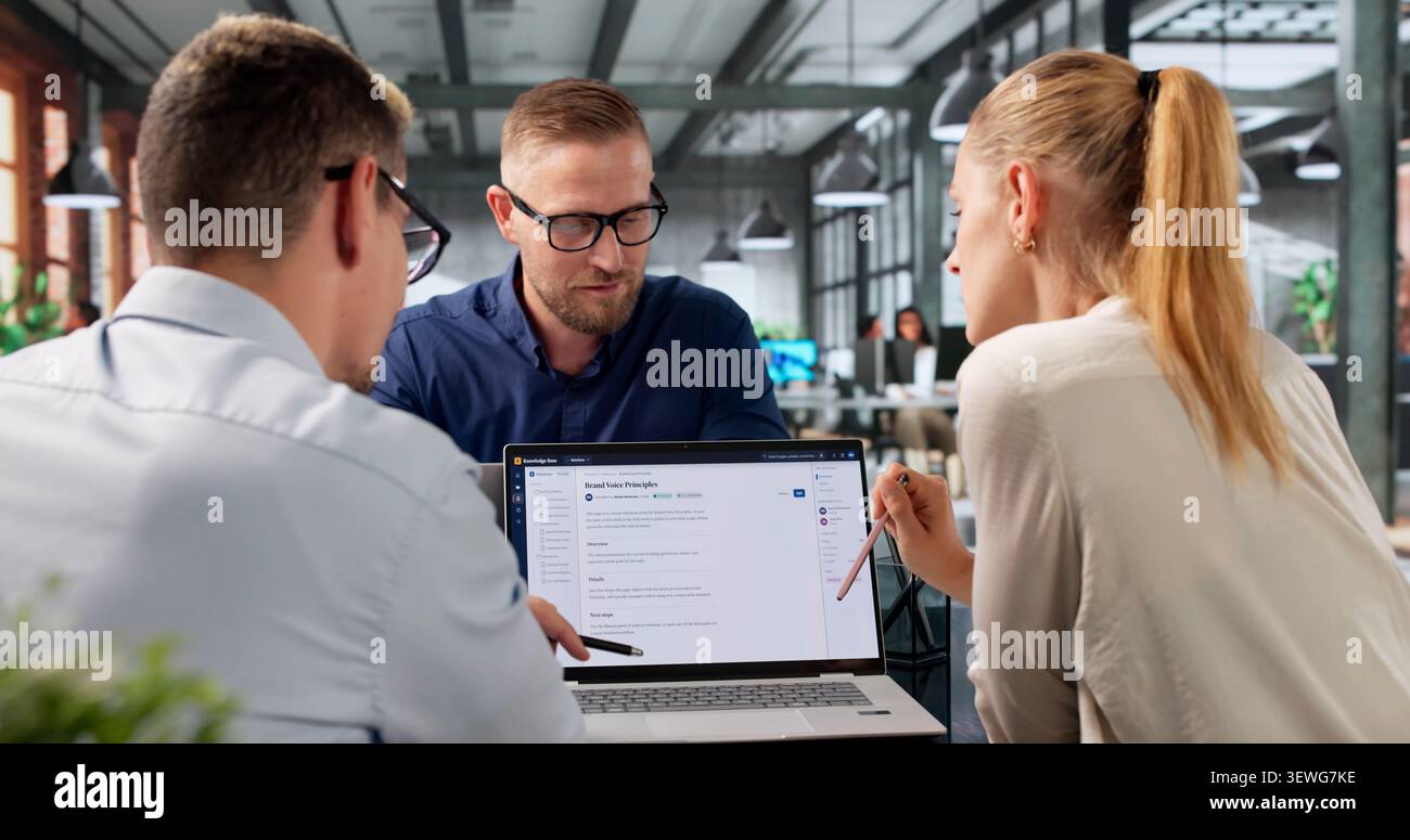 Diverse Team Collaborates On AI-powered Software Using Laptops And Cloud Systems. Stock Photo