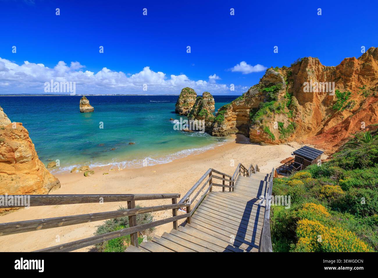 Algarve, Portugal. Costa de Oiro (Golden Coast). Wooden footbridge to beach Praia do Camilo. Stock Photo