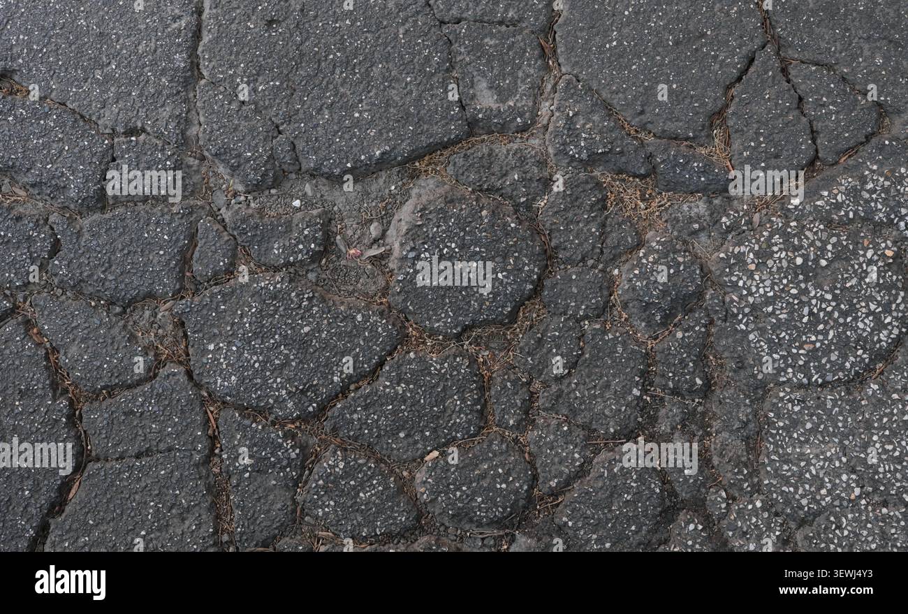 ABSTRACT BACKGROUND TEXTURE OLD CRACKED ASPHALT PAVEMENT Stock Photo