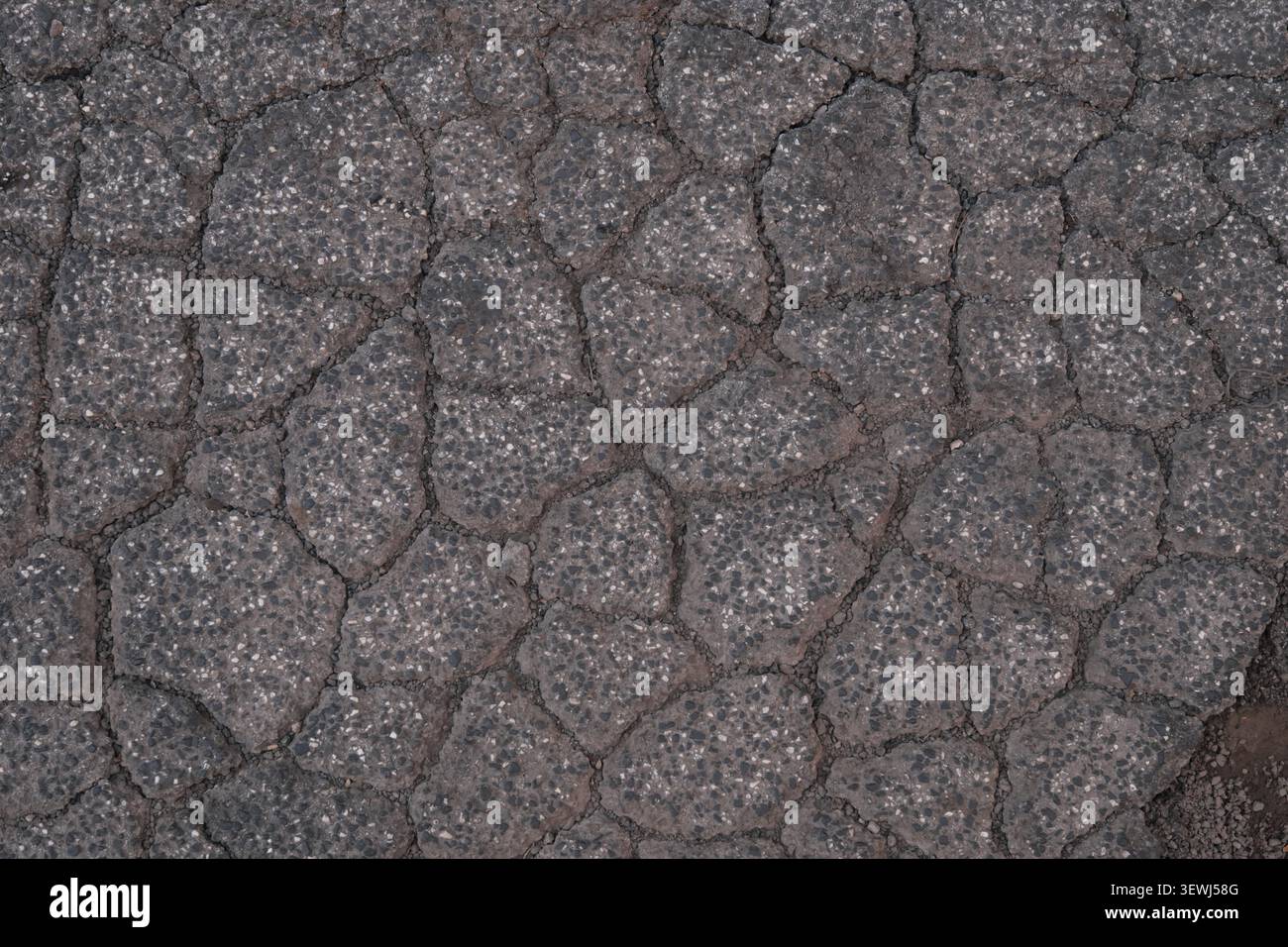 ABSTRACT BACKGROUND TEXTURE OLD CRACKED ASPHALT PAVEMENT Stock Photo