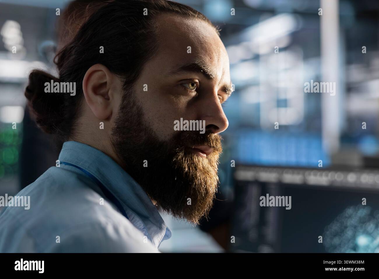 System administrator reviews artificial intelligence systems and machine learning processes inside a data center. Stock Photo