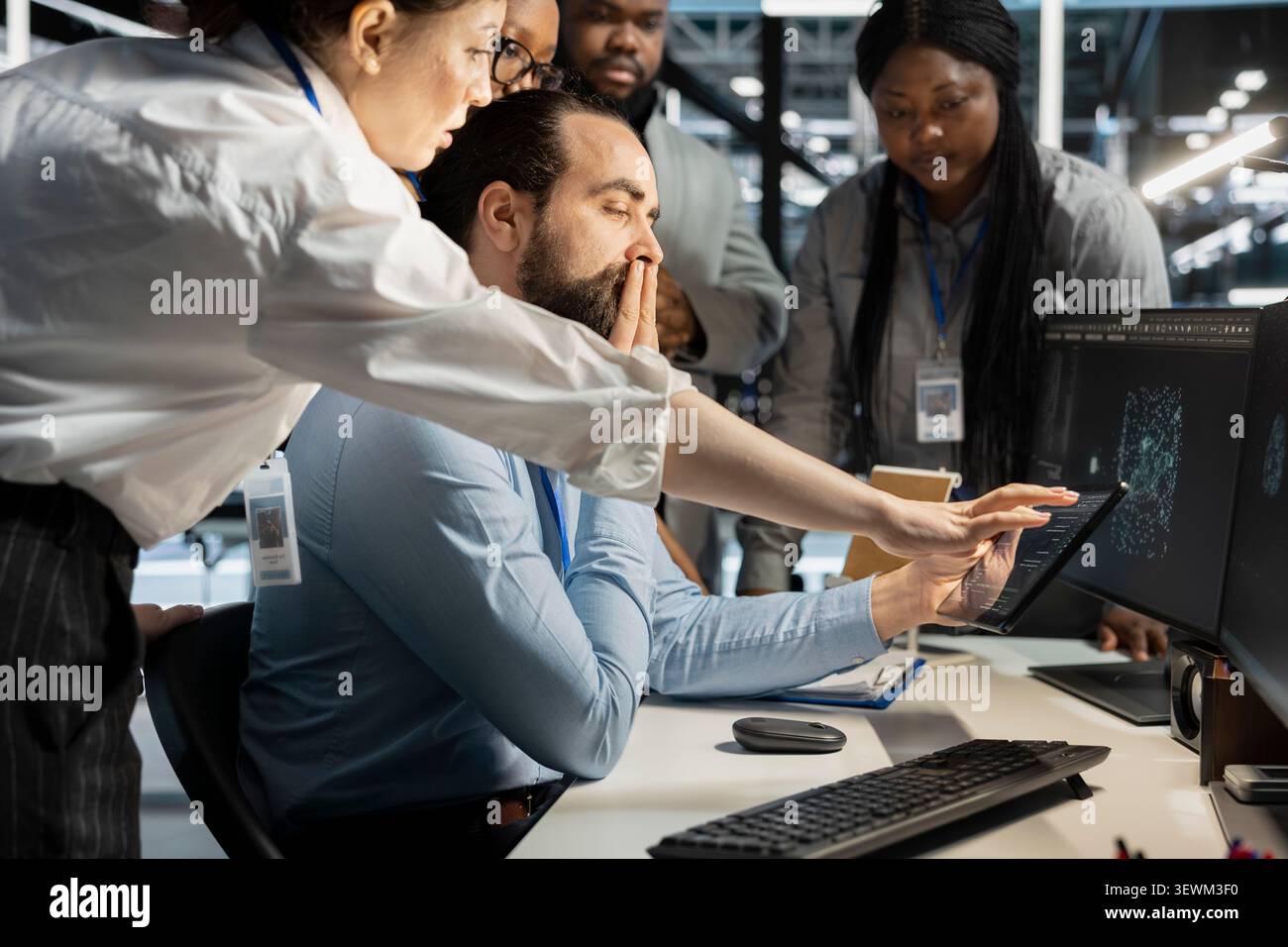 Data center colleagues collaborate on technical analysis and server infrastructure management inside a high-tech facility. Stock Photo