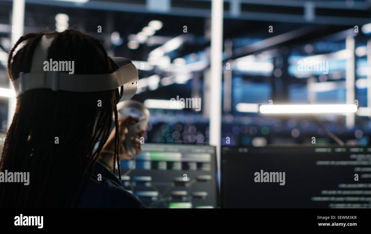 Administrator wears a headset in a server farm, using artificial intelligence troubleshooting to assist users. Stock Photo