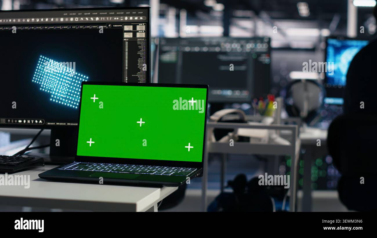 Computer scientist programs on a green screen computer in a data center with generative AI assistance. Stock Photo