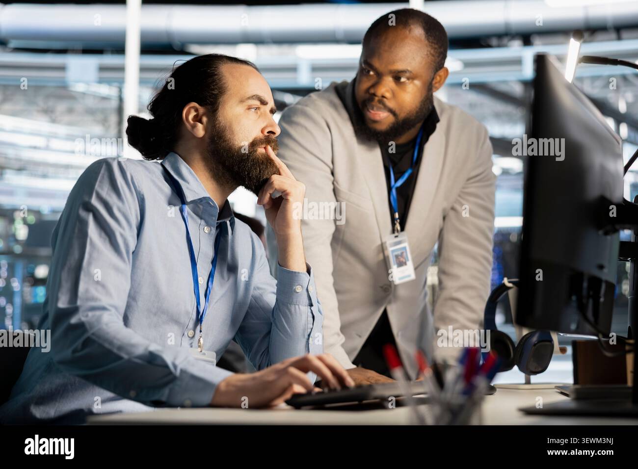 Data center manager reviews artificial intelligence systems and machine learning processes inside a data center. Stock Photo