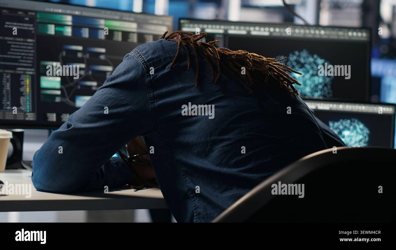 Data center engineer reacts to malfunctioning software and technical errors inside a server room. Stock Photo