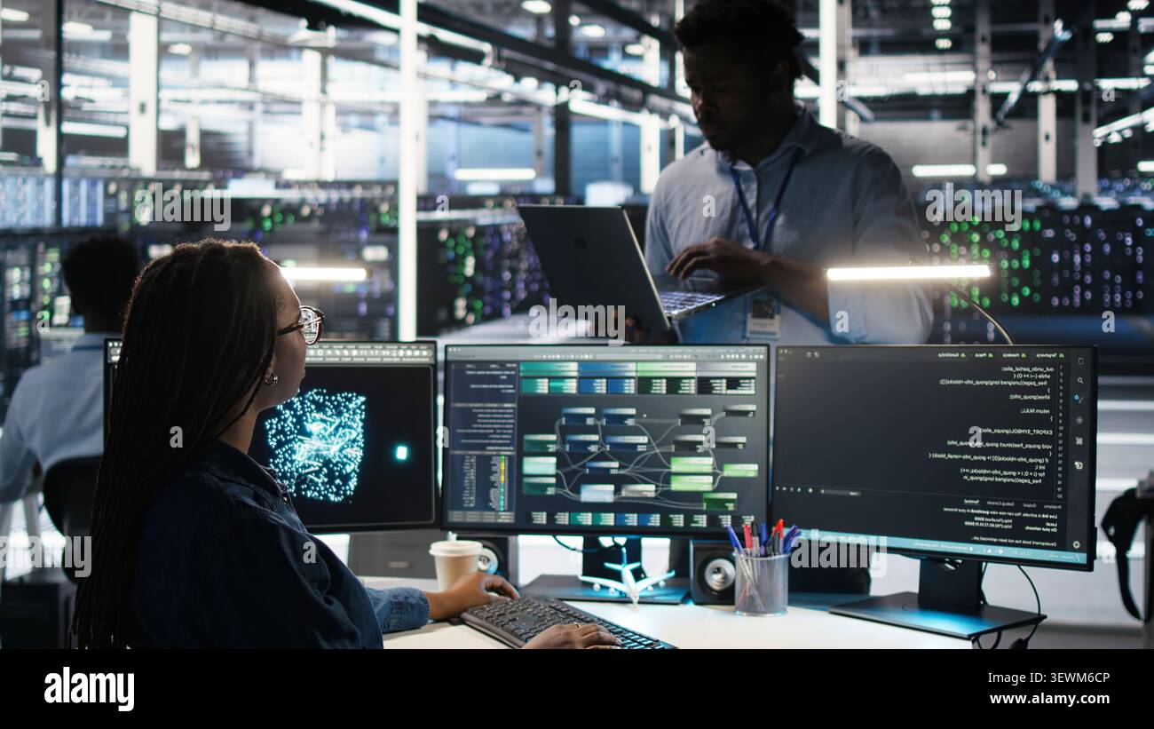 Engineer supervises node tree systems in a server farm while categorizing unstructured data. Stock Photo
