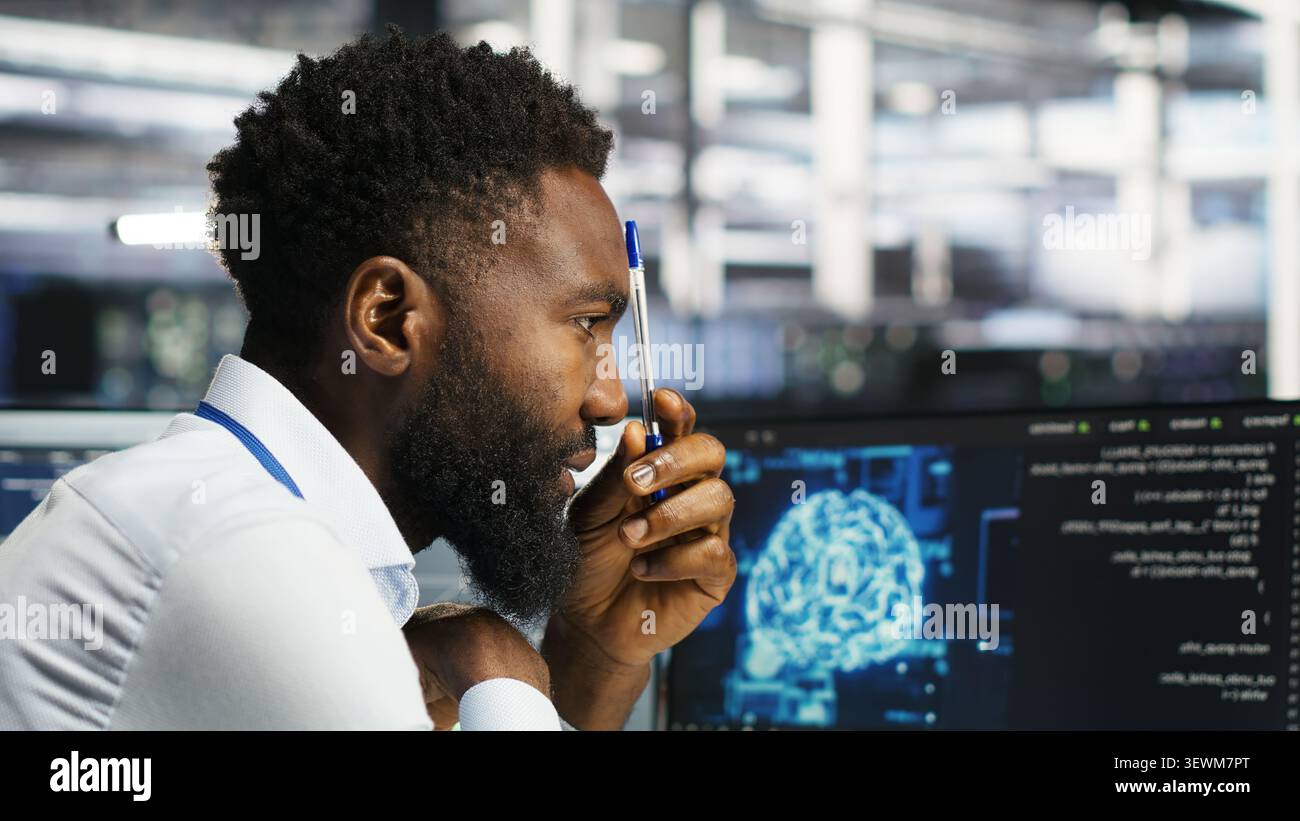 Programmer uses neural network node tree software to analyze infrastructure in a data center. Stock Photo