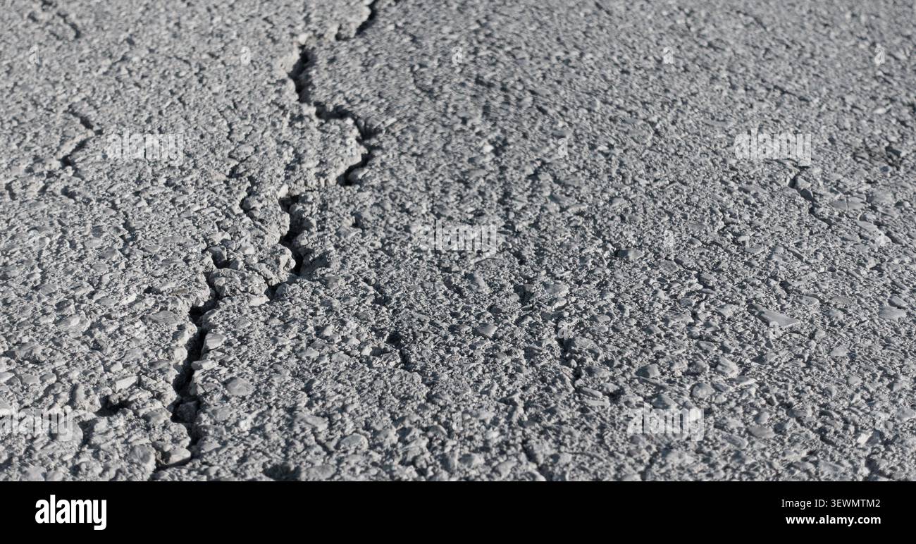 Cracked asphalt road surface Stock Photo