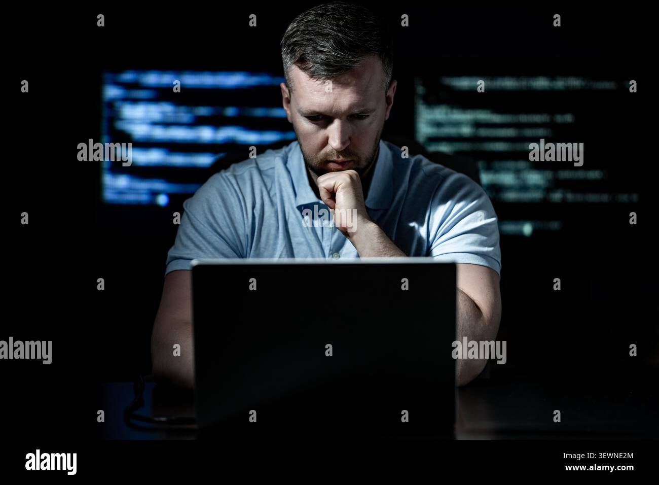 Hacker works on programming and coding. Hacker analyzes digital system vulnerabilities. Hacker monitors secure network infrastructure. Hacker attempts Stock Photo