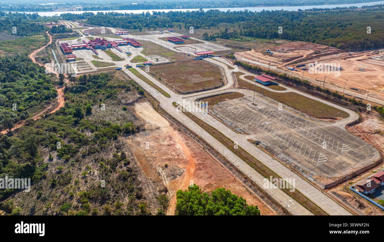 High angle drone shot of a landmark bridge connecting two nations, emphasizing engineering design, mobility, and economic progress in Southeast Asia. Stock Photo