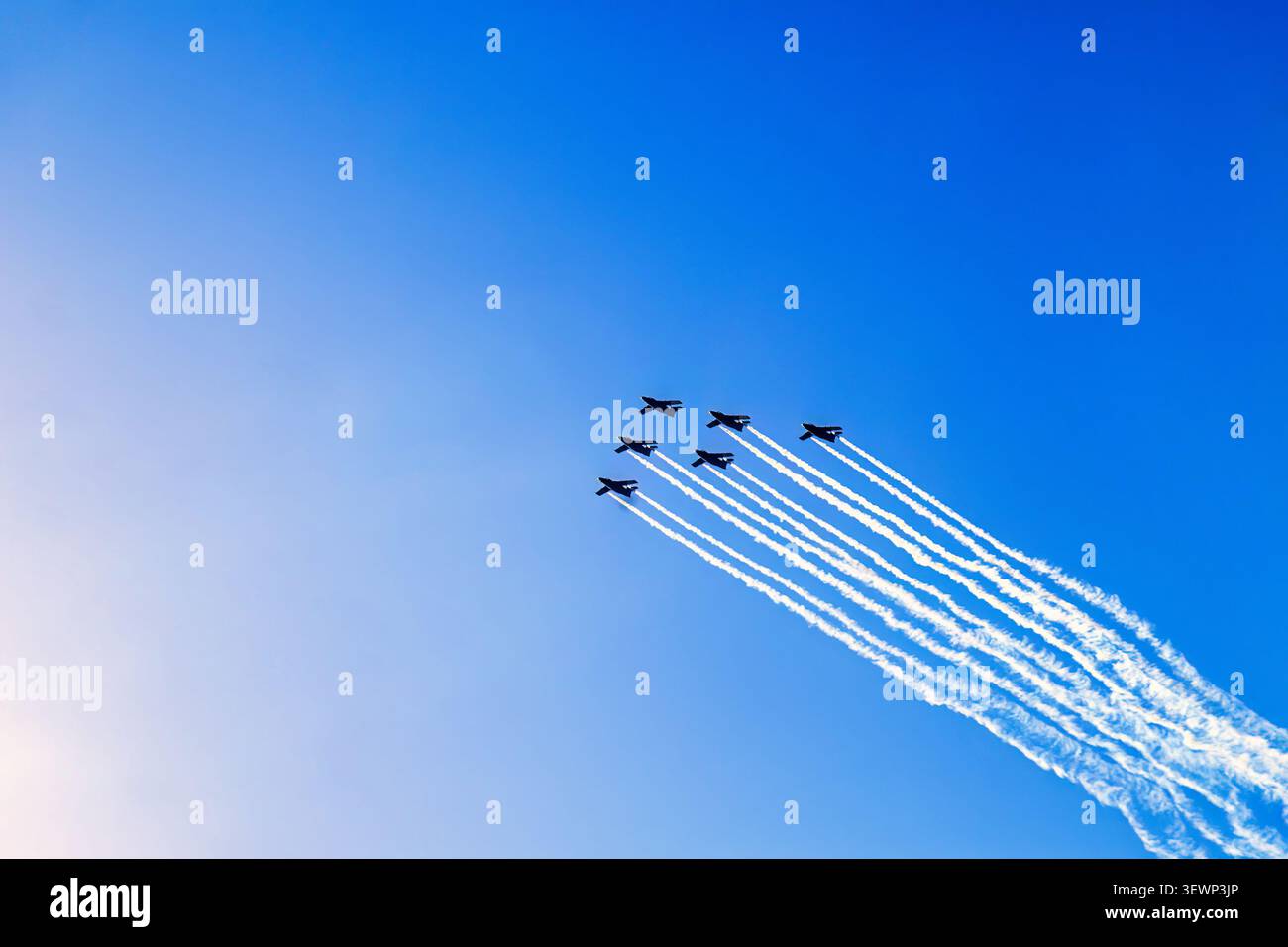 Fighter planes in formation flight with white condensation trails Stock Photo