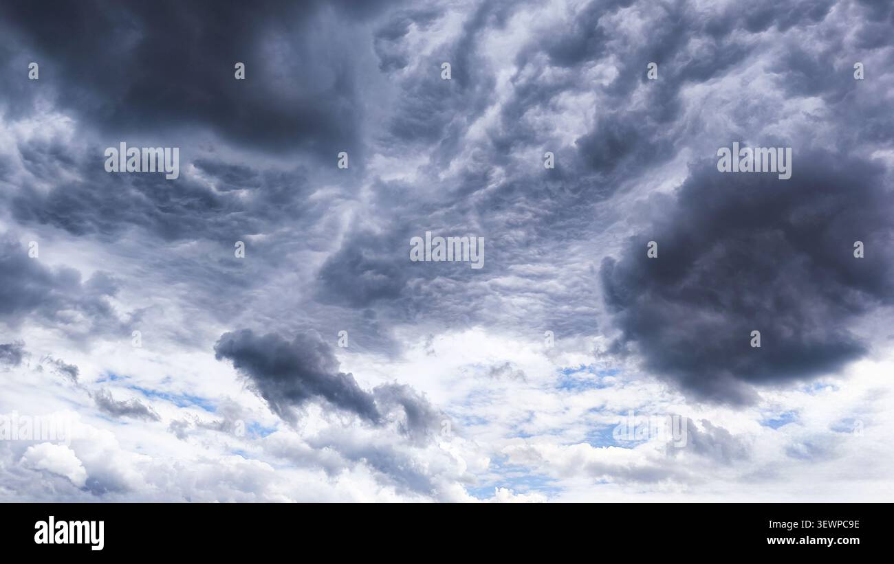 Dark storm clouds gathering across the sky before heavy rainfall. Stock Photo