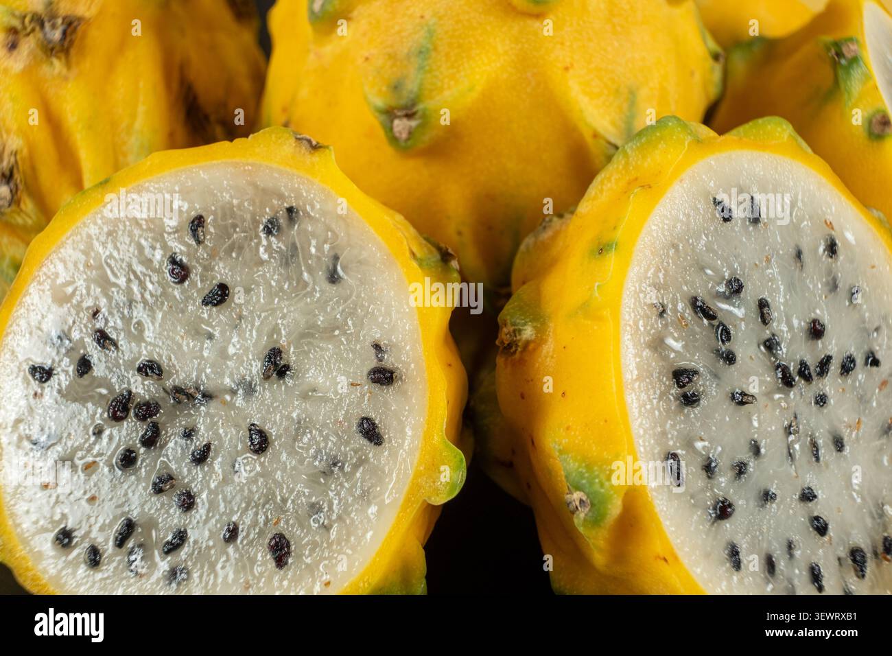 Cut ripe yellow pitahaya fruits close up view. Stock Photo