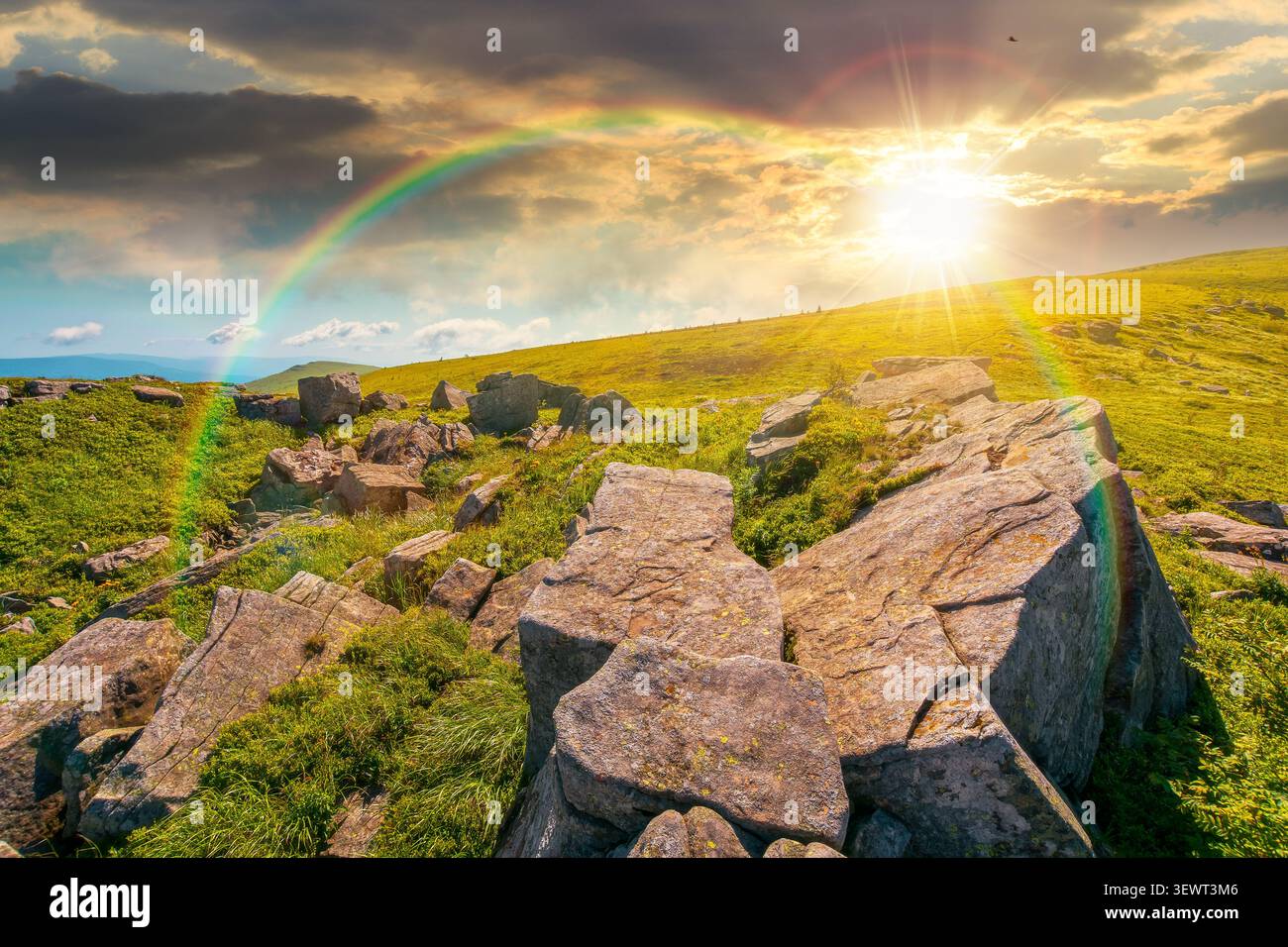 sunset over alpine grassy meadow. carpathian mountains landscape with huge boulders. alpine nature scenery of ukraine highlands in summer. view of rem Stock Photo