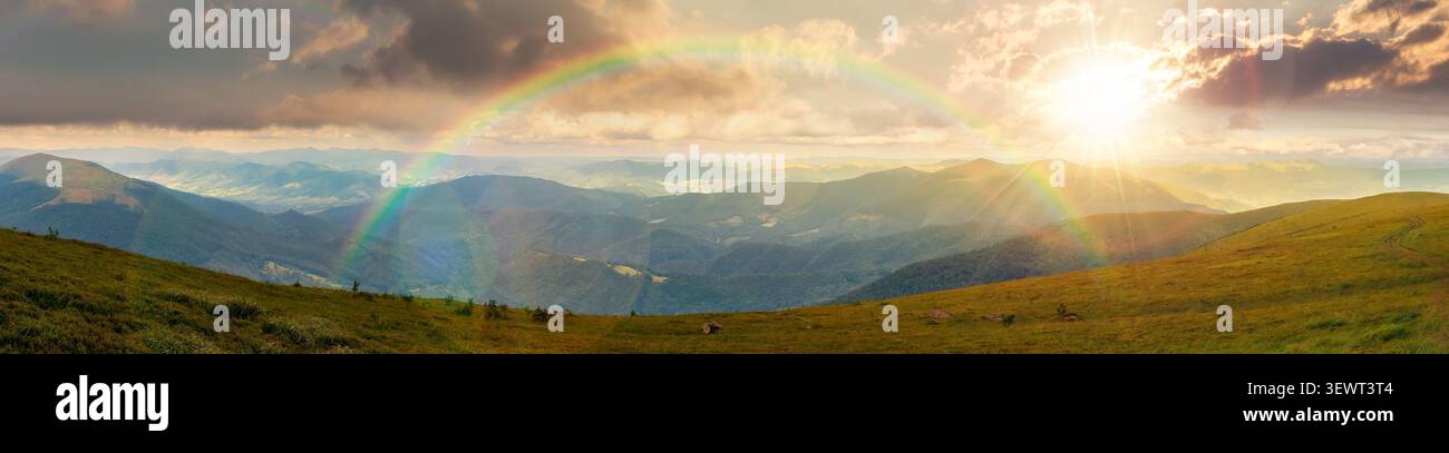 beautiful panorama of mountainous landscape at sunset. wide view of cloudy sky over the grassy slope of a mountain ridge. lovely summer weather with r Stock Photo