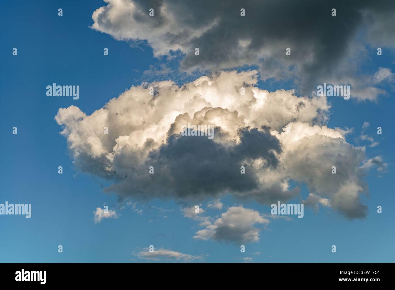 Towering Cumulus Clouds with Dramatic Light and Shadow Stock Photo