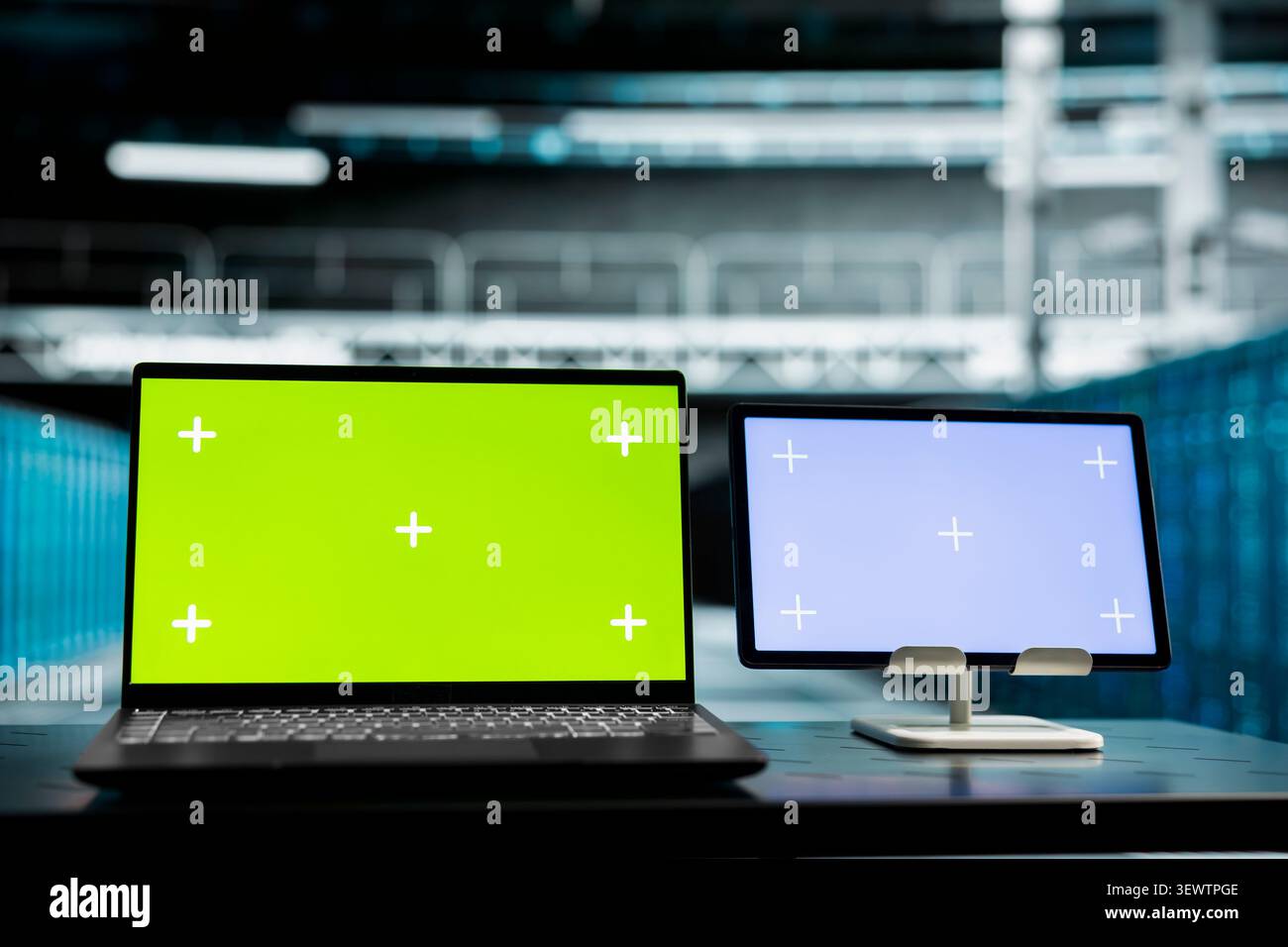Concerned mockup device reviews warning messages in a data center while troubleshooting errors affecting equipment performance. Stock Photo