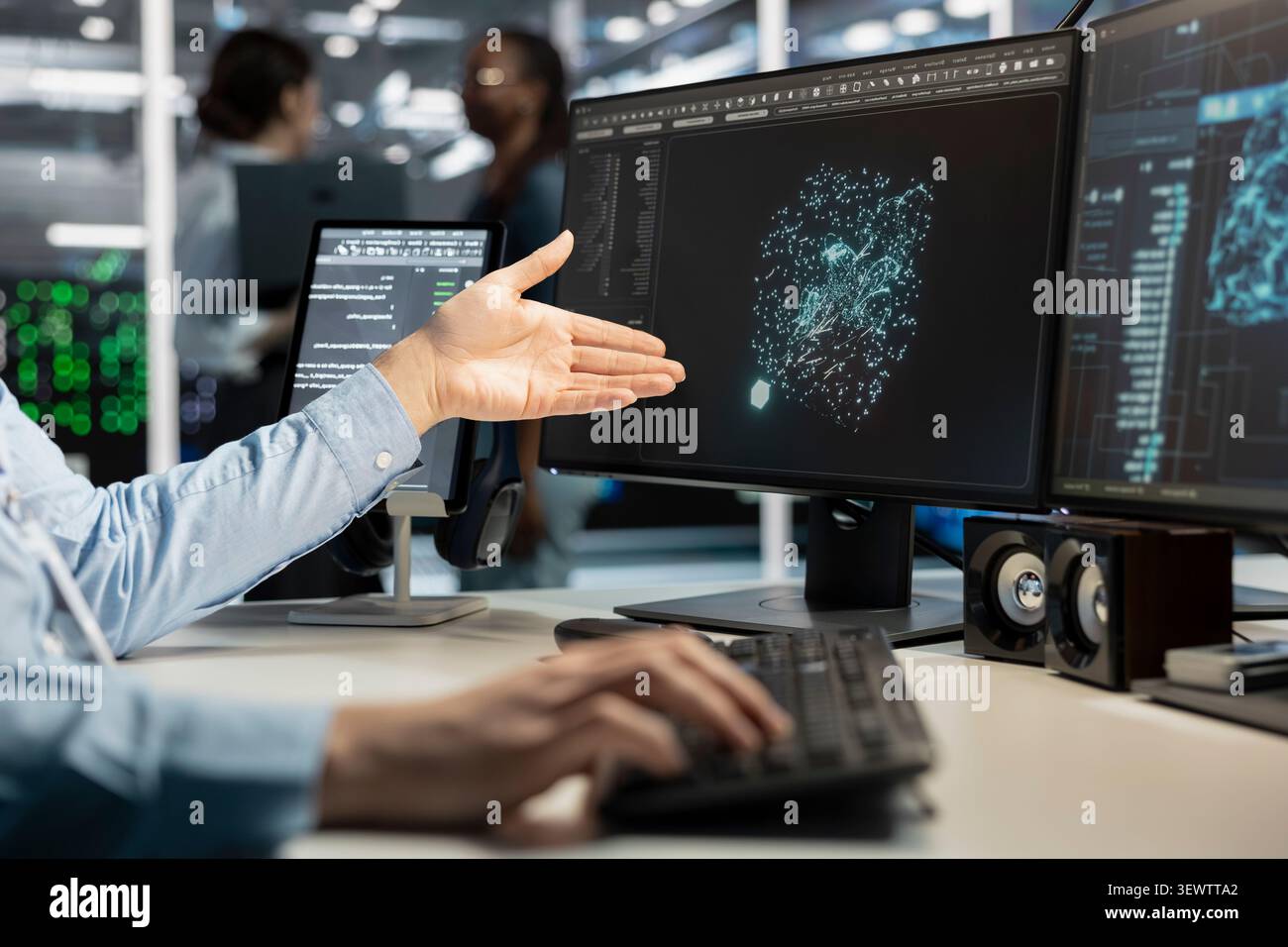 Data center programmer uses a desktop computer in a data center to manage AI virtualization and optimize server infrastructure. Stock Photo