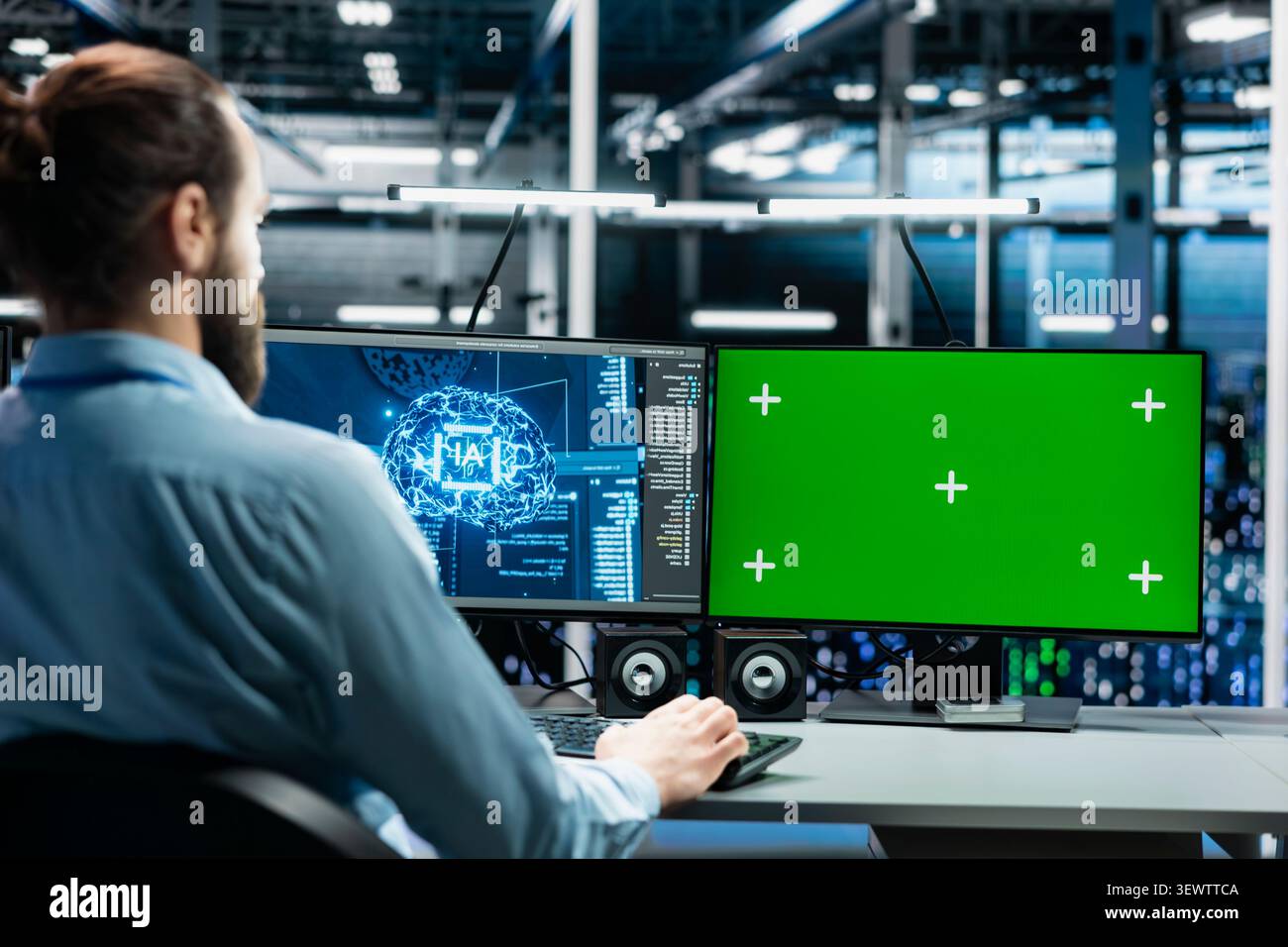 Software developer uses a green screen computer to manage AI systems, machine learning workflows and server performance. Stock Photo