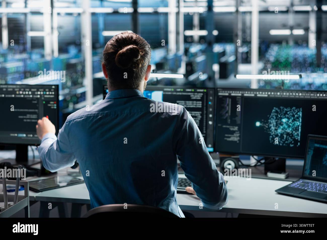 Engineer uses an AI language model assistant in a server room to handle infrastructure maintenance. Stock Photo