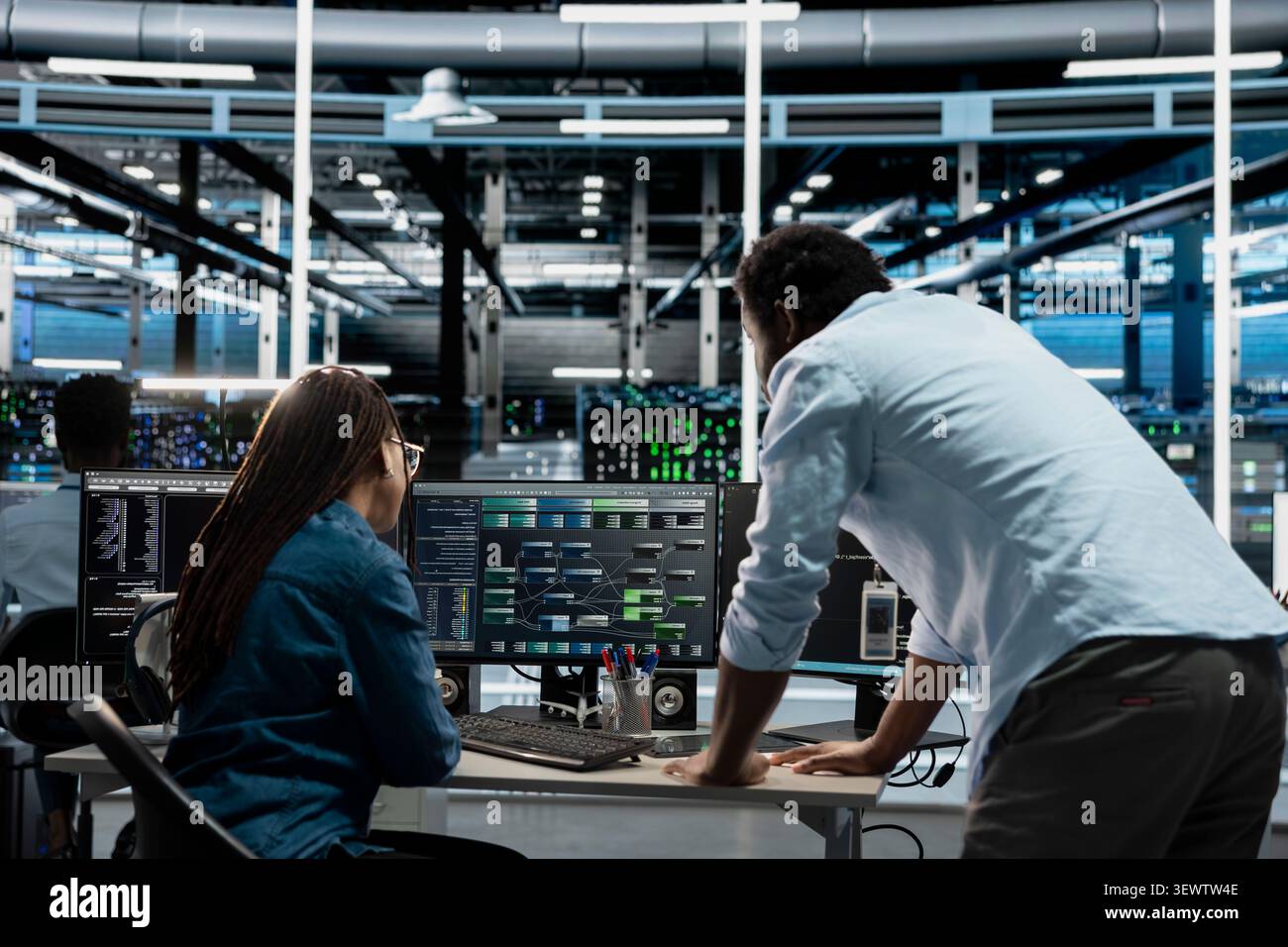 Computer scientists program data center equipment for machine learning training, upgrading AI systems with code on a PC. Stock Photo