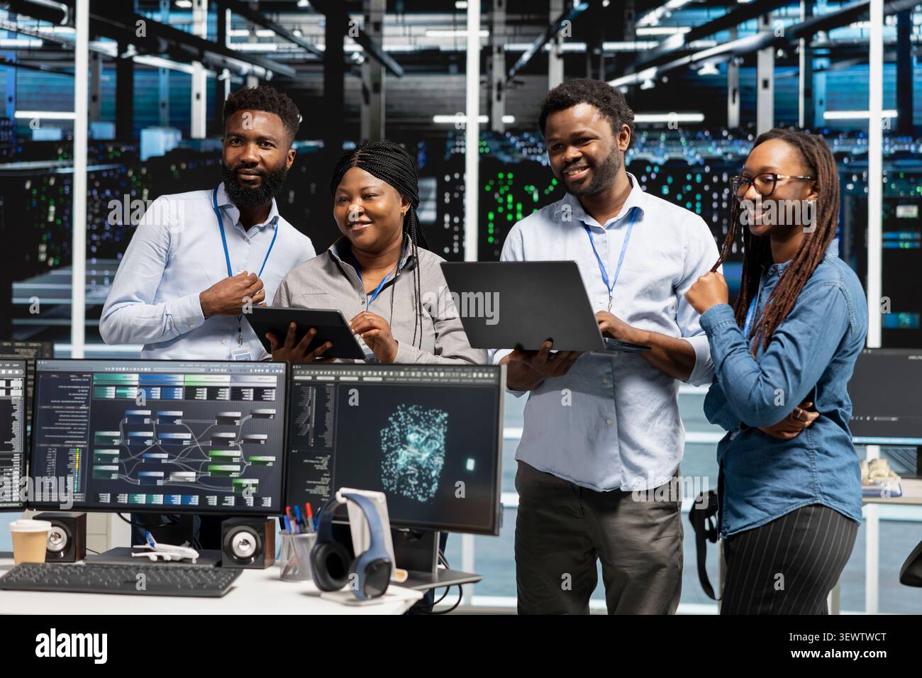Cheerful high tech server room specialists collaborating, working with deep learning algorithms. Stock Photo