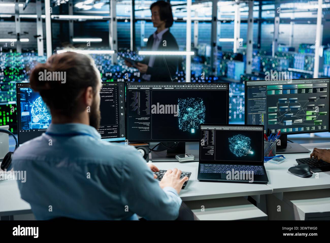 Software programmer working in high tech server room with hardware managing AI training datasets with IT staff member overseeing machine learning tech in server facility supporting scalable digital. Stock Photo