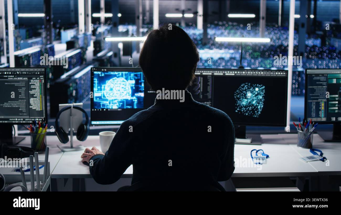 Data infrastructure center system administrator working on AI neural network software development, while implementing machine learning technology in workplace. Stock Photo