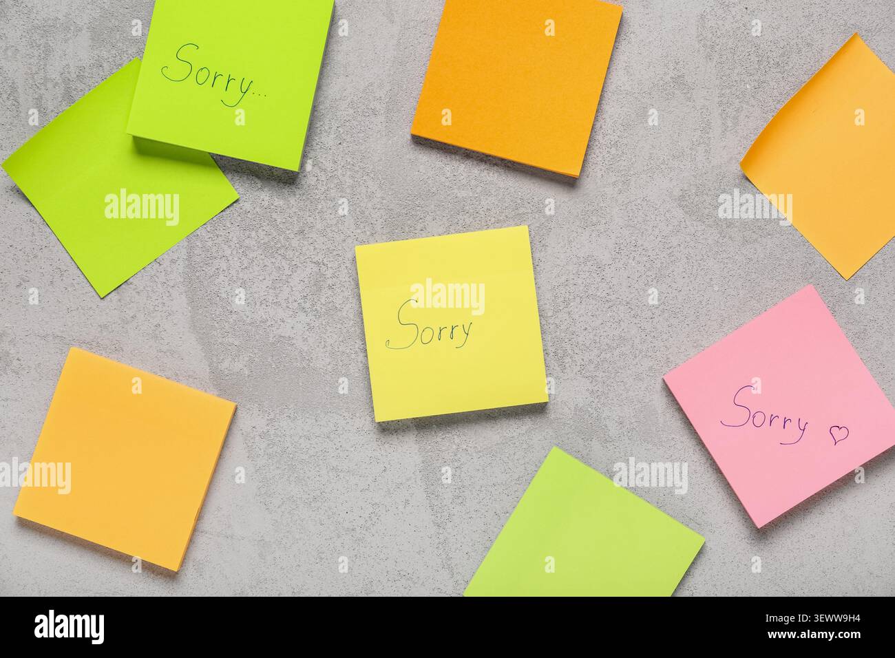 Sticky notes with word SORRY on grunge background Stock Photo