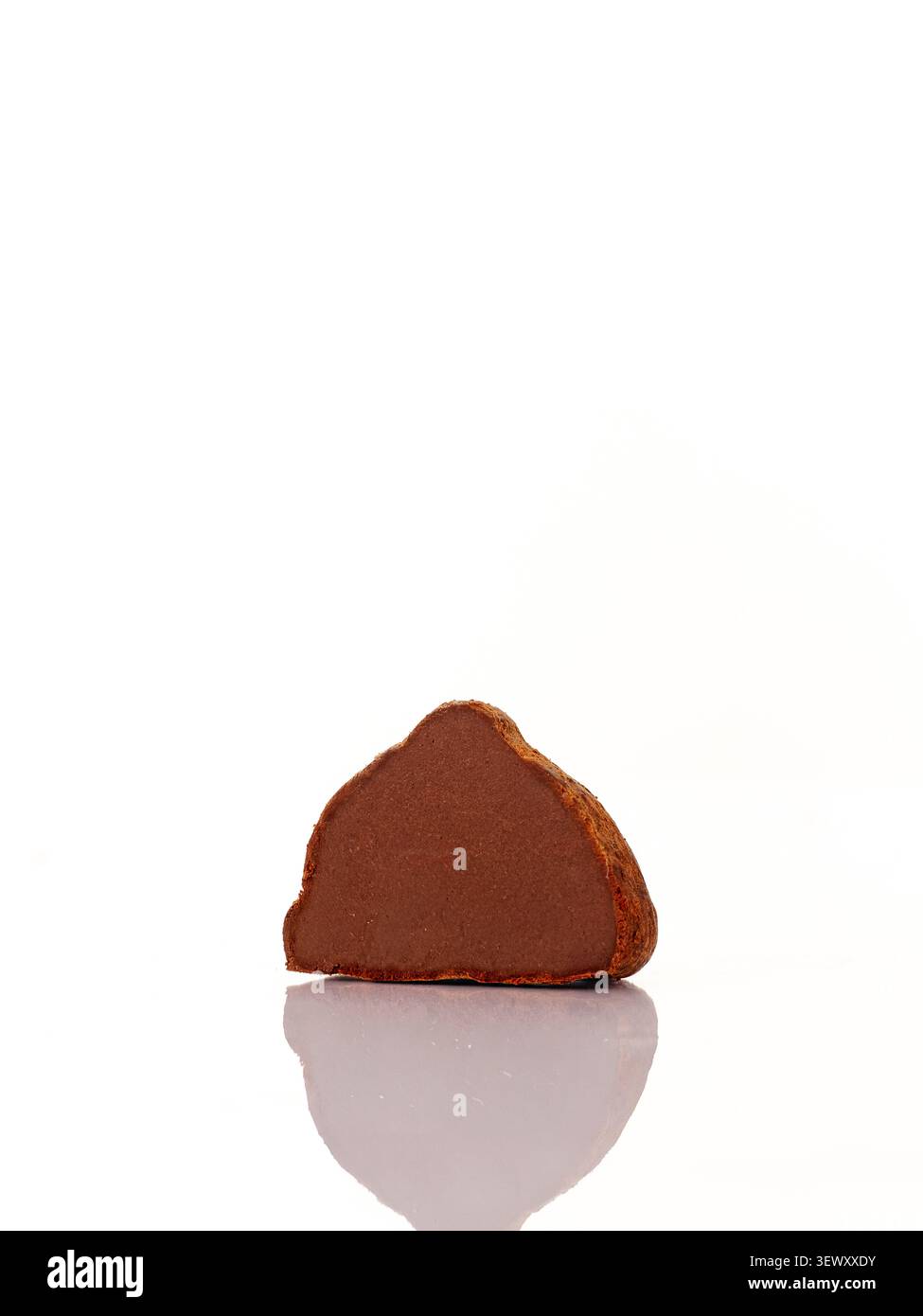 Chocolate truffle cut in half on white background Stock Photo