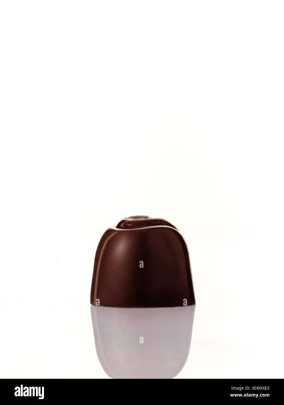 Single gourmet dark chocolate candy on white Stock Photo