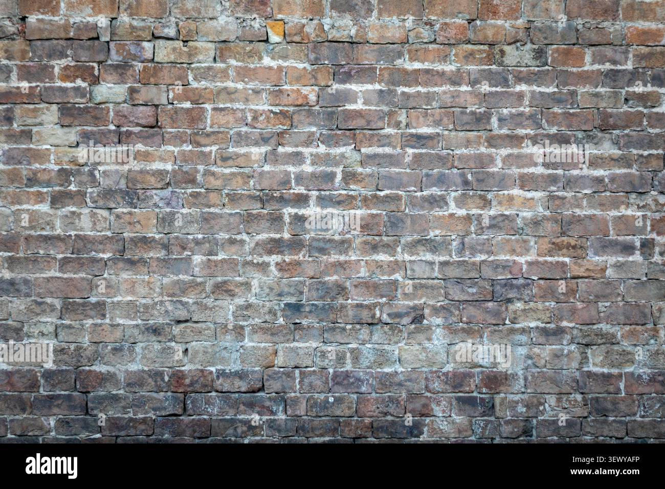 Aged weathered brick wall texture background with rustic urban masonry detail Stock Photo