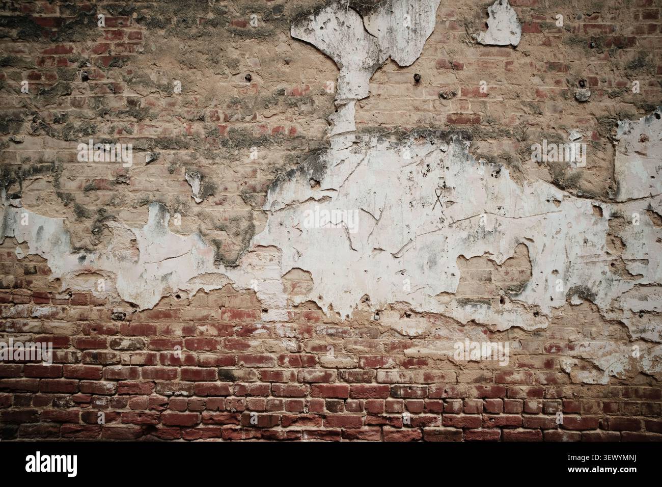 Old brick wall and peeling plaster Stock Photo