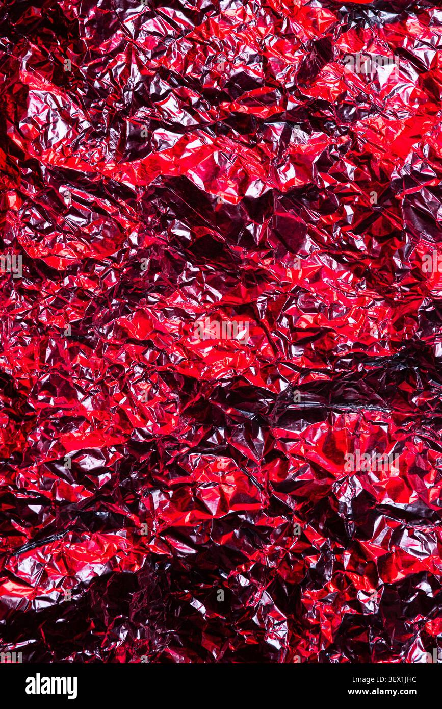Abstract Red Metallic Foil Surface Texture Background With Wrinkles And Crinkles Stock Photo