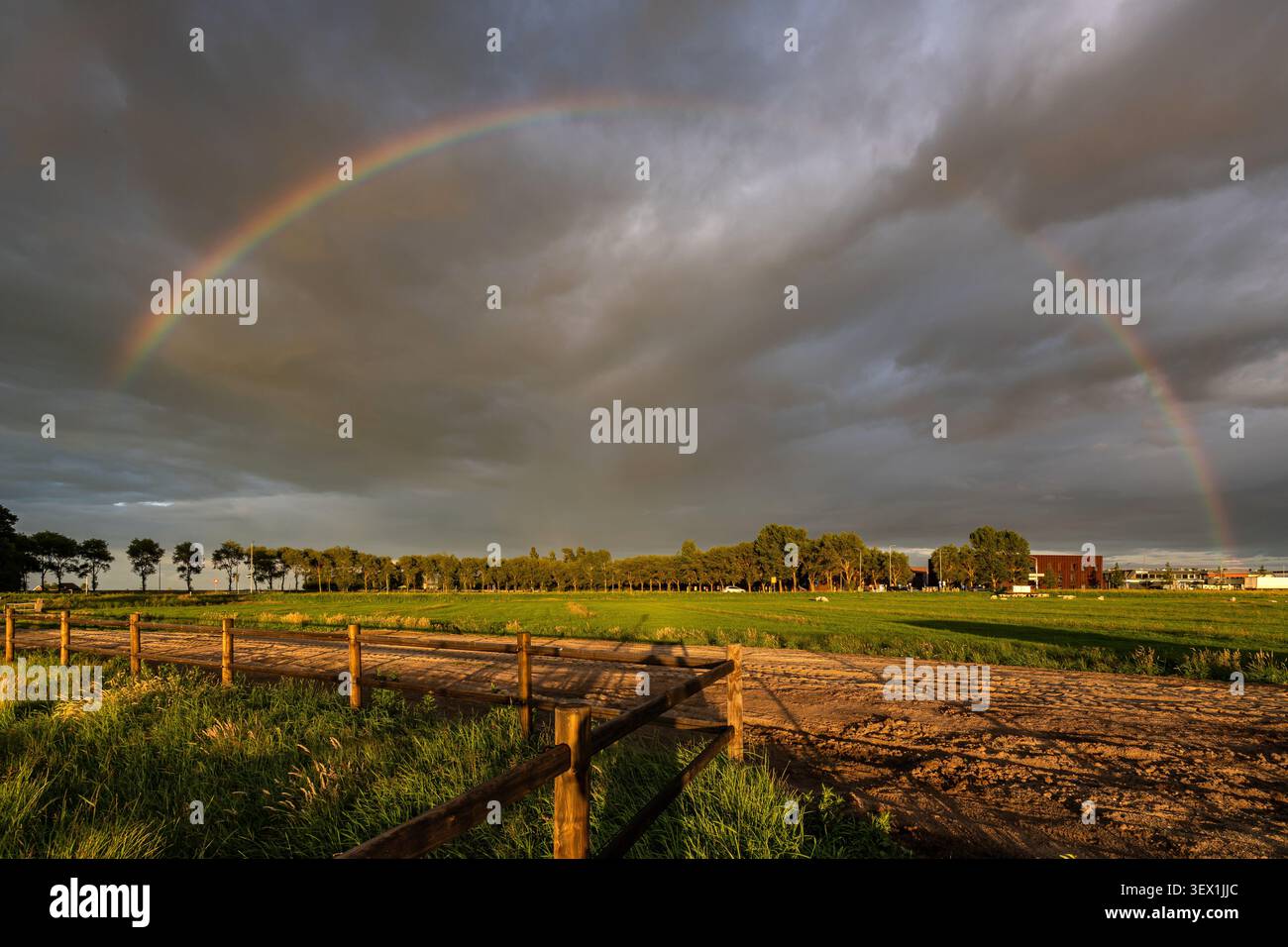 full-arc rainbow stretching across a dramatic sky Stock Photo