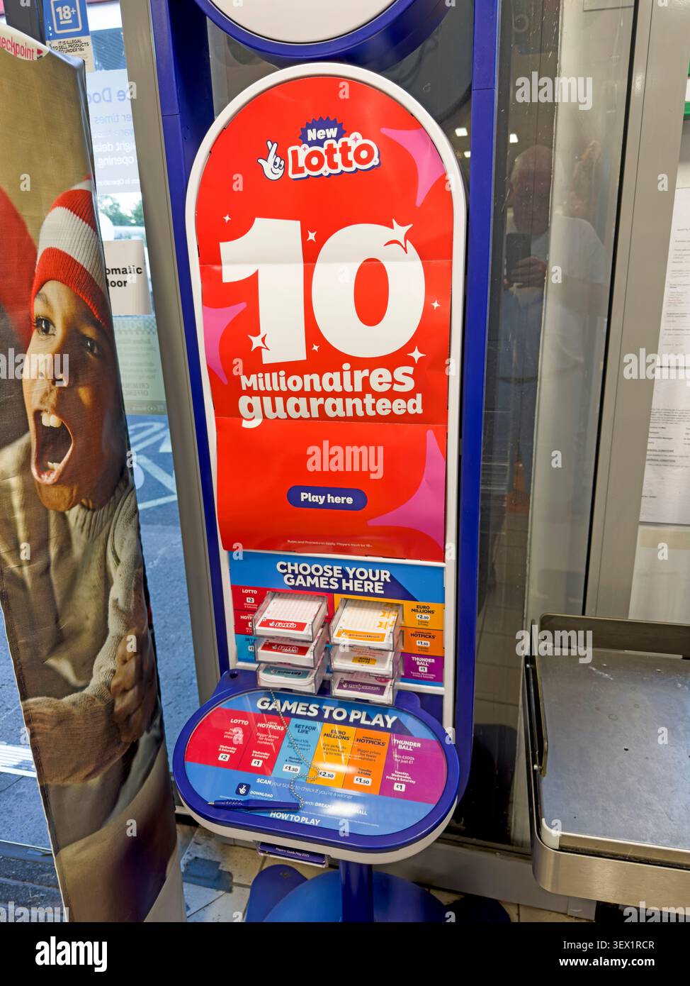 UK shop lottery terminal advertises 10 guaranteed millionaires amid debate over gambling normalisation, affordability and harm Stock Photo