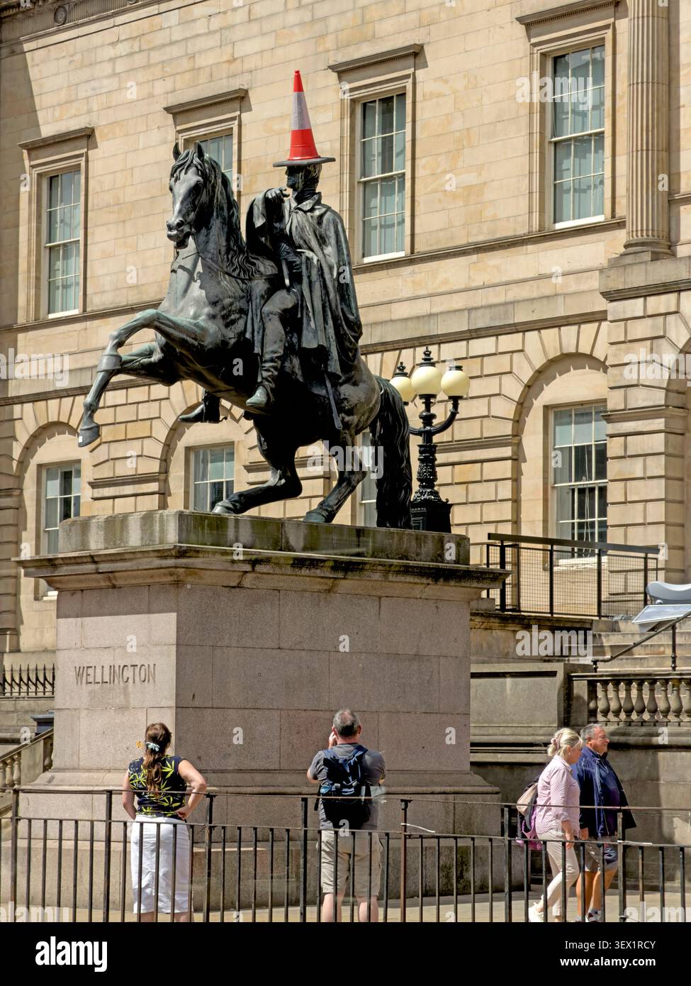 Traffic cone placed on Edinburgh’s Duke of Wellington statue outside General Register House, echoing a familiar Scottish urban prank Stock Photo