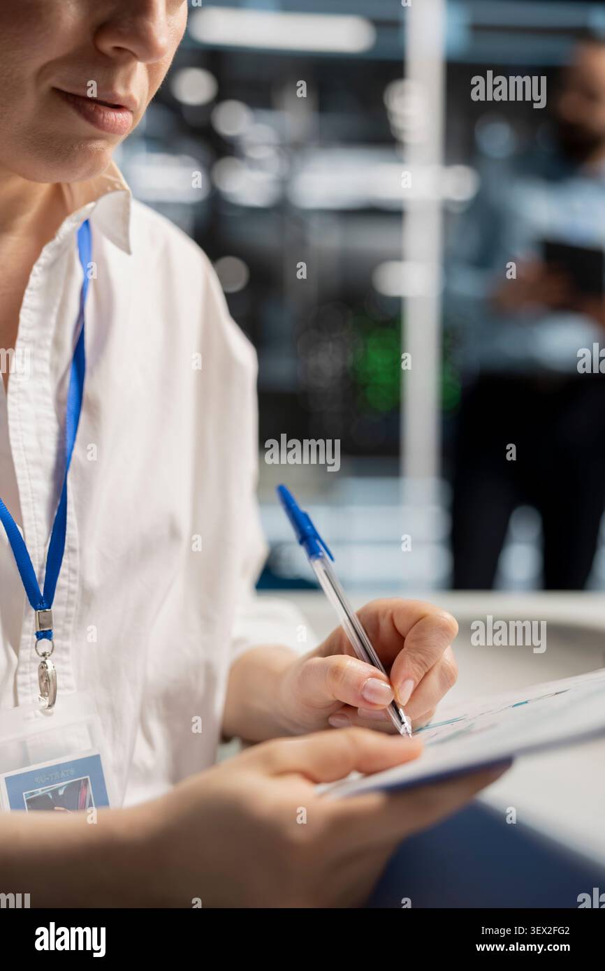 System operator uses a desktop computer in a data center to support supercomputer management and reliable server workflows. Stock Photo