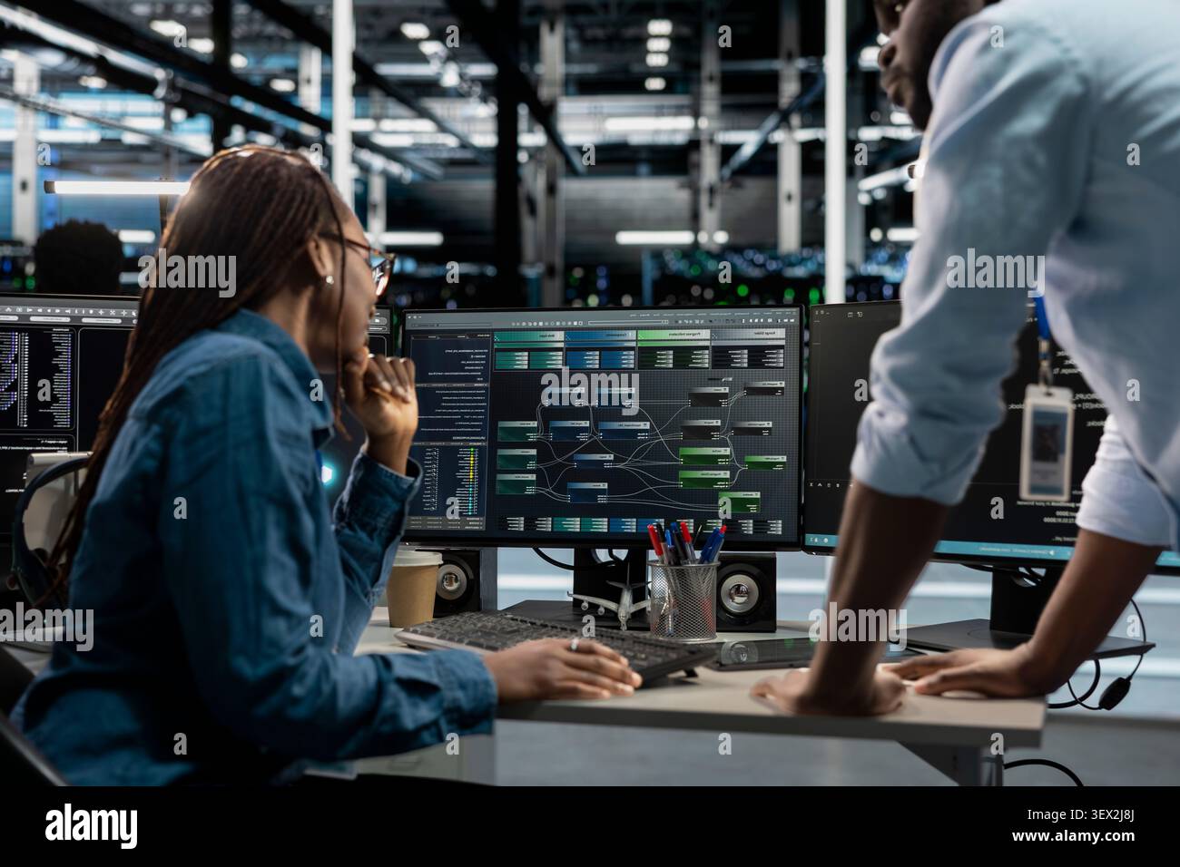 System administrator reviews node tree software to analyze datasets and improve server infrastructure performance. Stock Photo