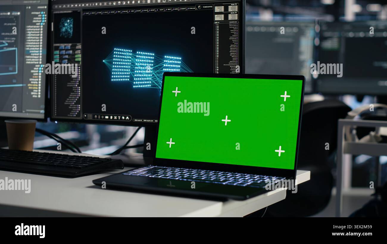 Software developer uses a green screen laptop to manage AI systems, machine learning workflows and server performance. Stock Photo