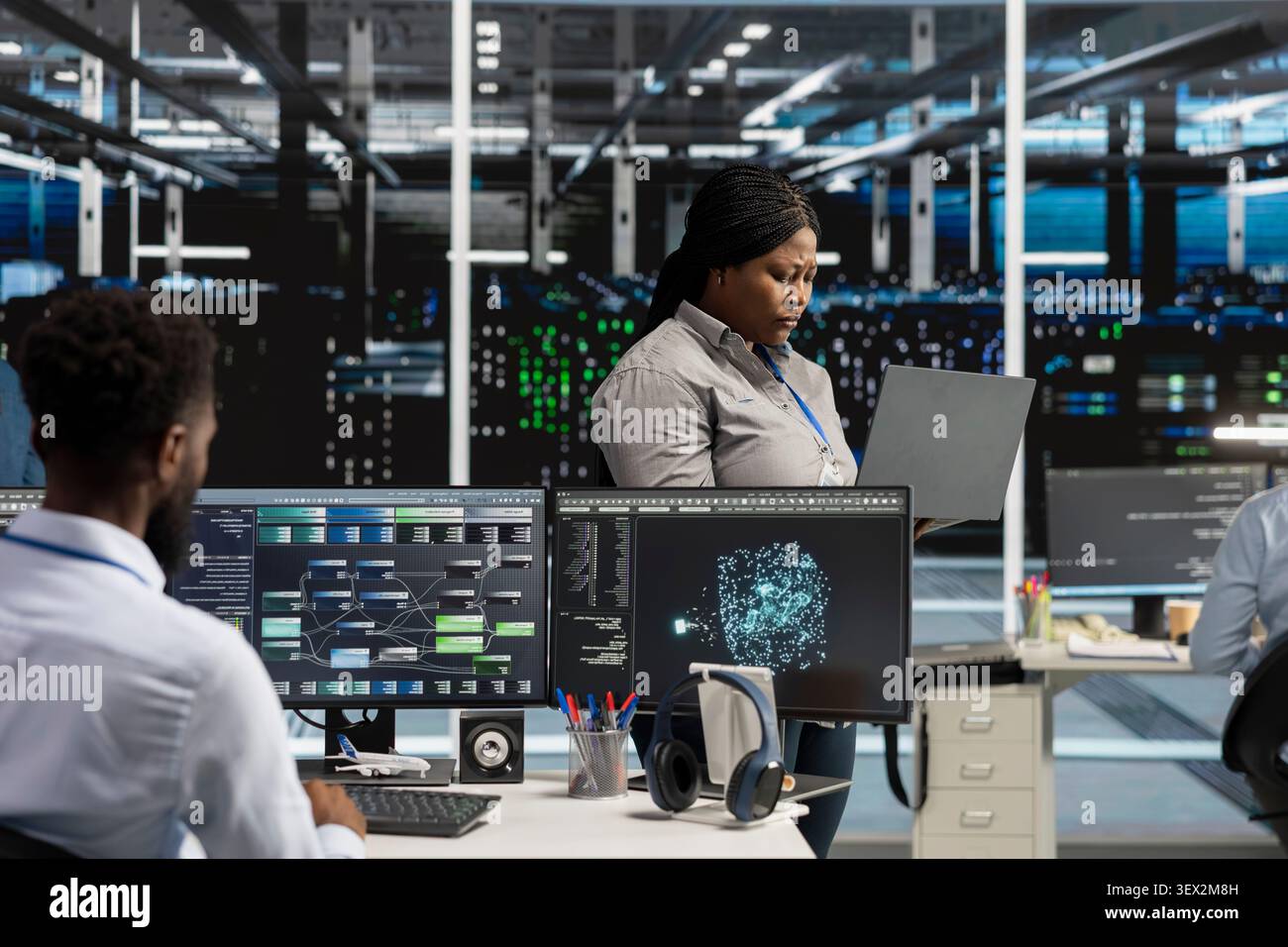 Data center manager reviews artificial intelligence systems and machine learning processes inside a data center. Stock Photo